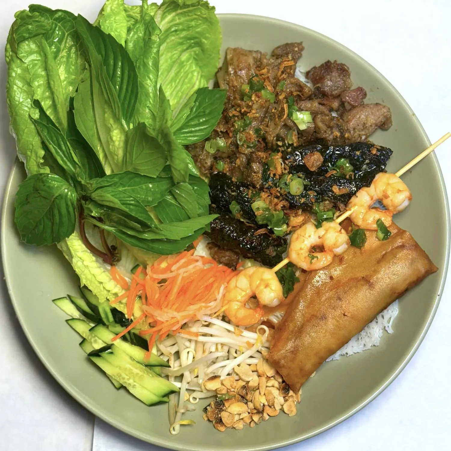 Assorted vermicelli platter with shrimp skewer and egg roll at Magnolia Pho, a Vietnamese Restaurant in Seattle
