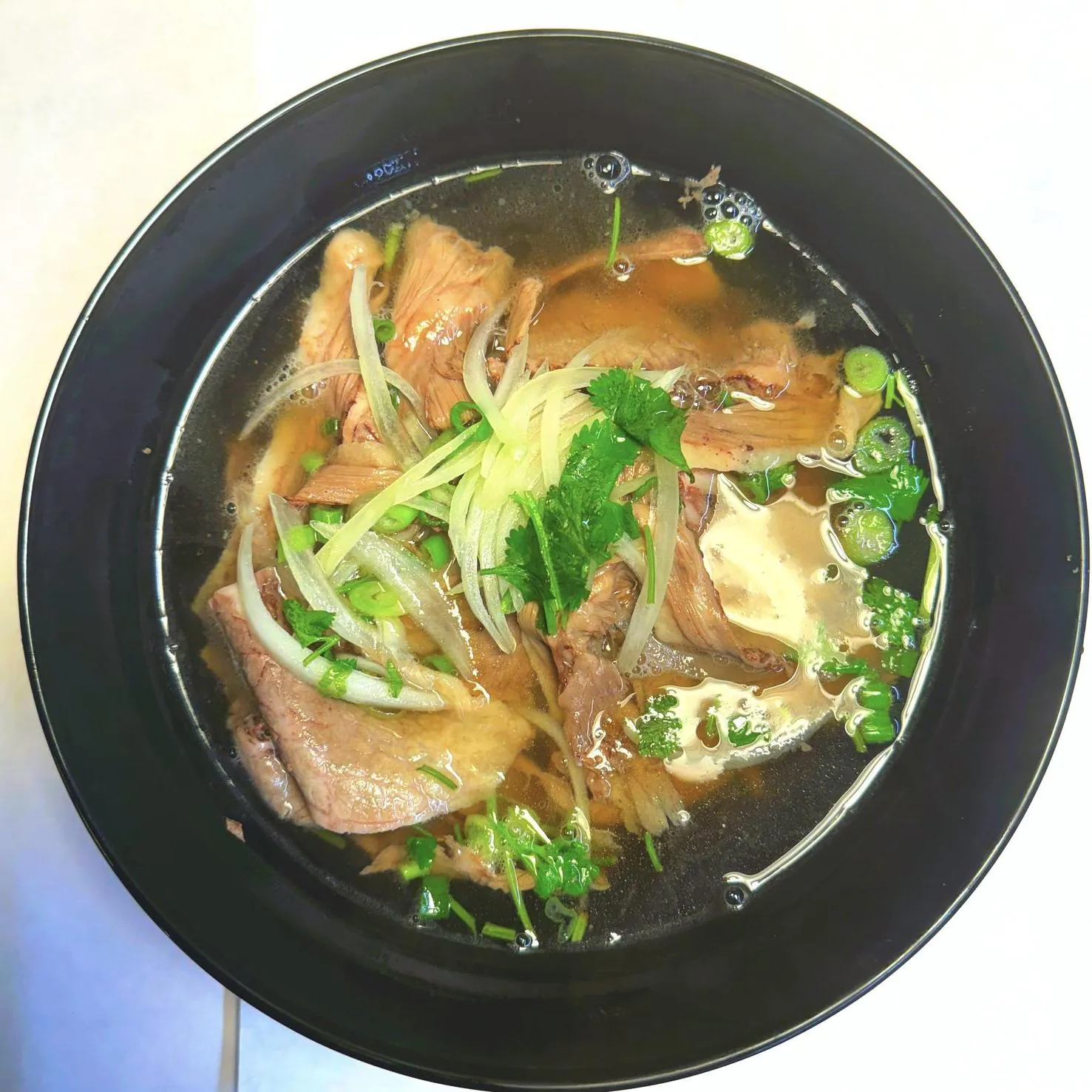 Aromatic beef pho with tender beef and herbs at Magnolia Pho, a Vietnamese Restaurant in Seattle