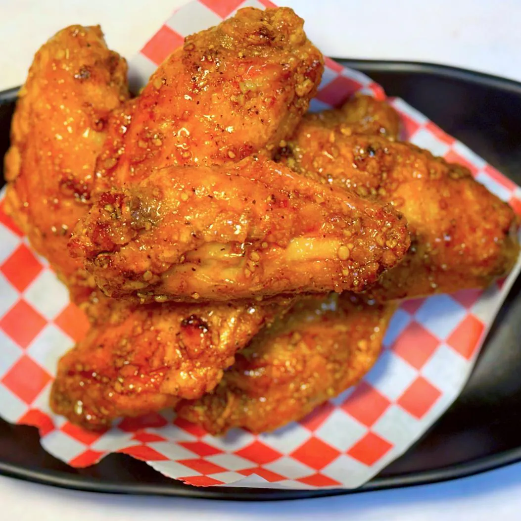 Spicy glazed chicken wings with rich seasoning at Magnolia Pho, a Vietnamese Restaurant in Seattle