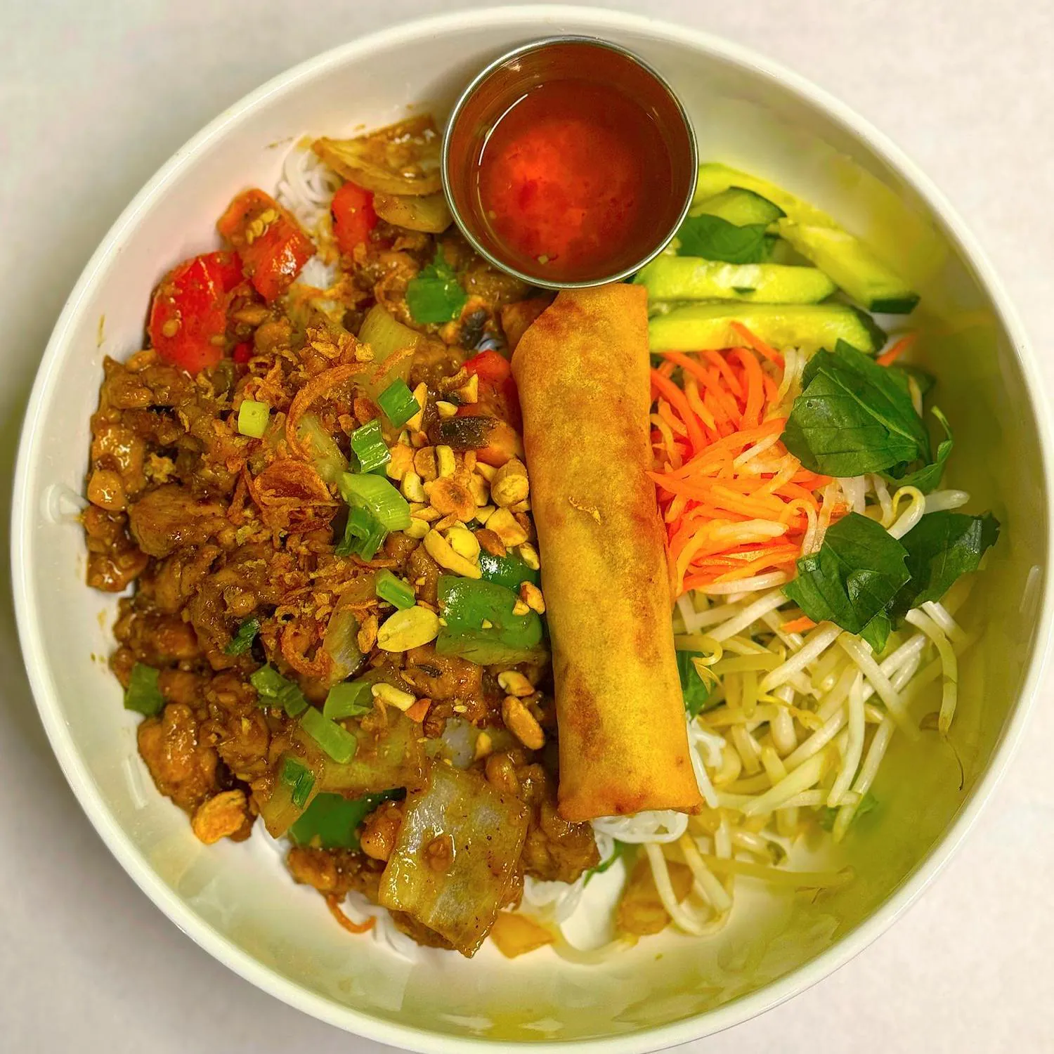 Magnolia-Pho-Vietnamese-Restaurant-Curry-Chicken-Vermicelli-Bowl-with-Egg-Roll-Seattle Curry chicken vermicelli bowl with egg roll and veggies at Magnolia Pho, a Vietnamese Restaurant in Seattle